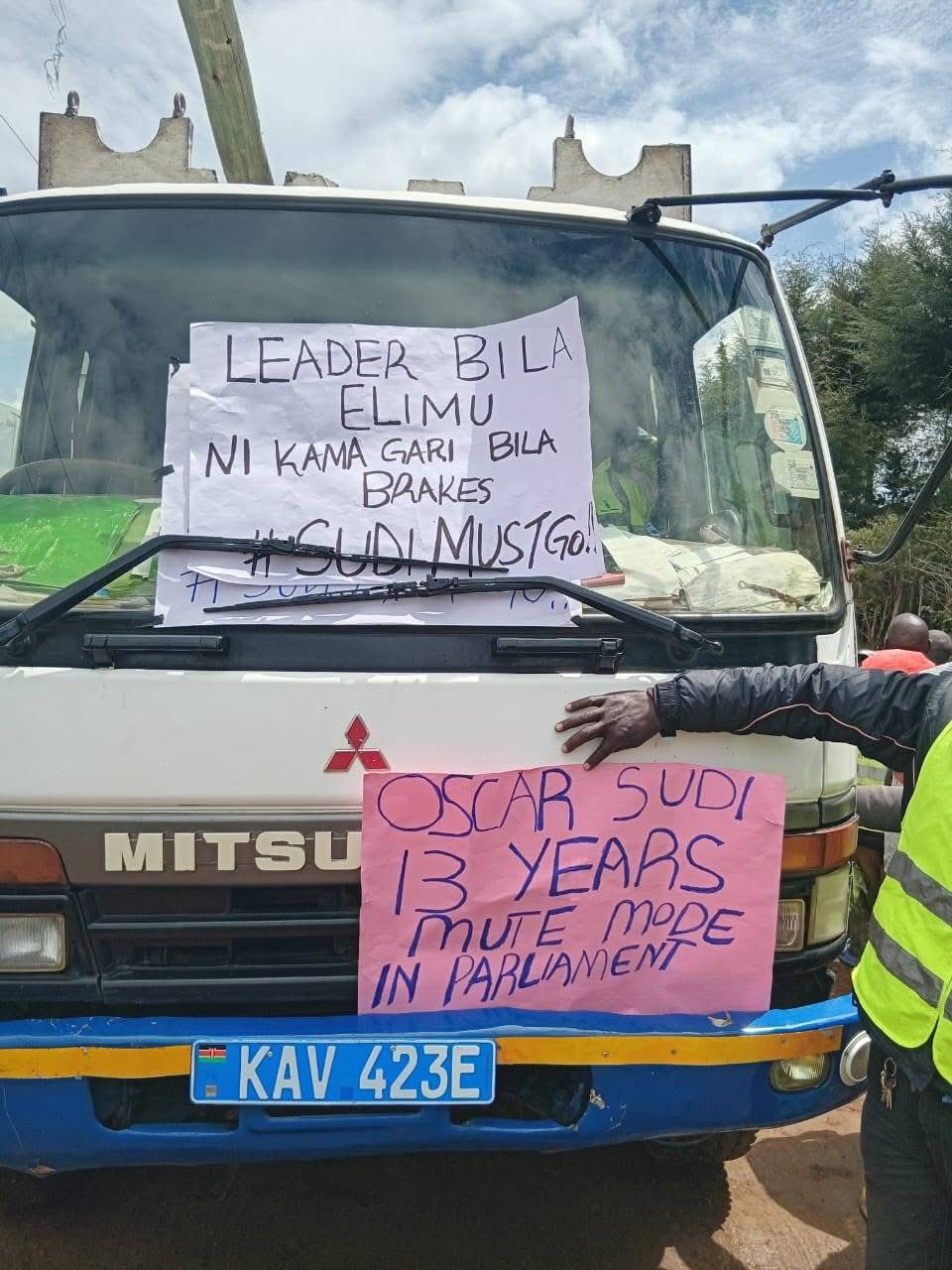 May be an image of 1 person, car and text that says 'LEADER BILA ELIMU NI KAMA GARI BILA BRAKES SUDIMUSTO OSCAR SUDI MITSU 13 YEARS ME MODE IN PARLIAMENT K 423E'