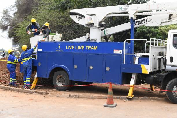 Kenya Power and Lighting Company live line experts prepare to use an articulated lift to relocate power lines to pave way for the construction of the...